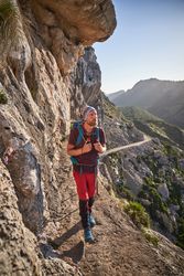 Male hiker walking along mountain path