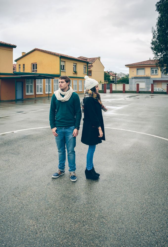 Couple standing away from each other in circle in sports court
