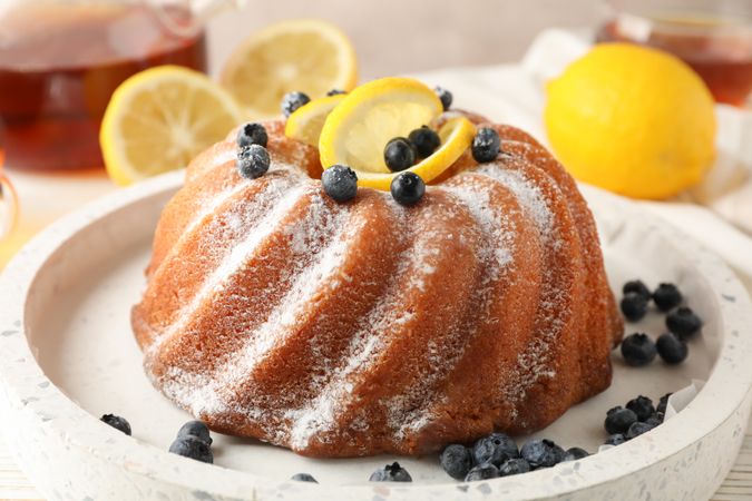 Cake with powder sugar and lemon, close up