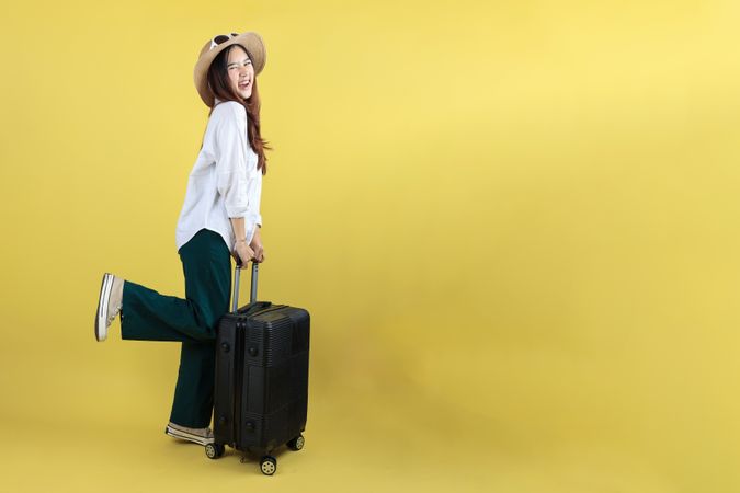 Happy Young Asian Tourist Woman Holding Suitcase Taking Vacation Trip