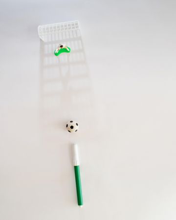 Top view of toy soccer field with pen, school concept
