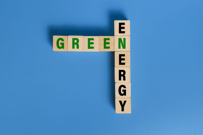 green energy words text on wooden blocks isolated on blue background