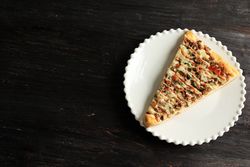 Top view of pizza drizzled with condiments and space for text