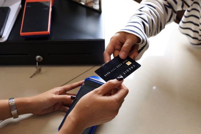 Close Up Female Customer Paying with Credit Card