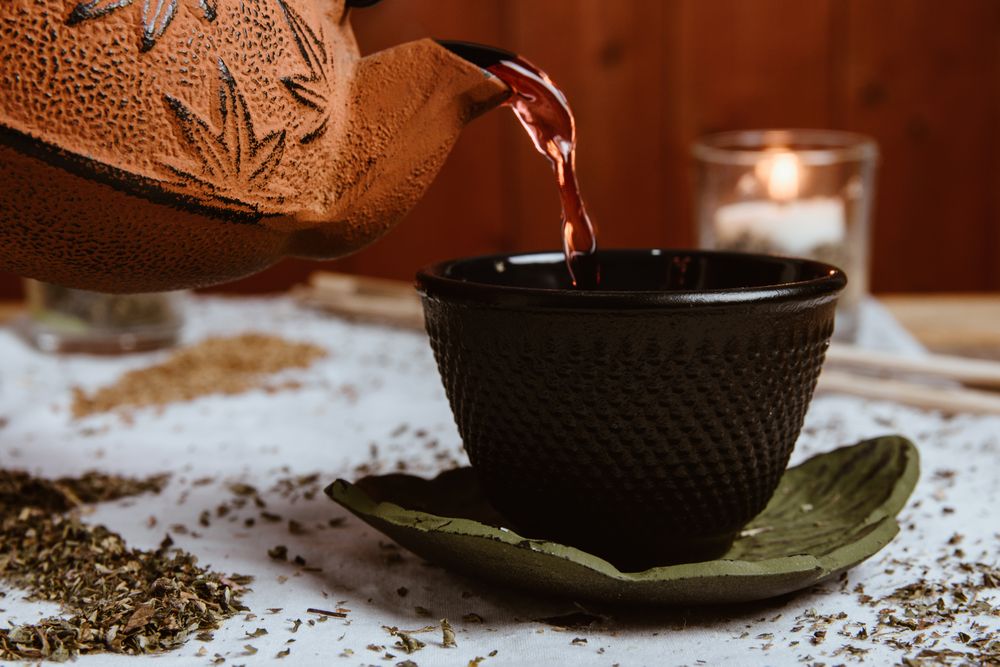 Aromatic tea dates and clay teapot on table