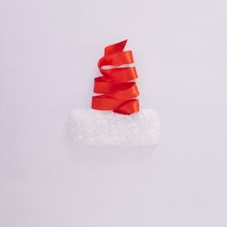 Red ribbon making Santa hat