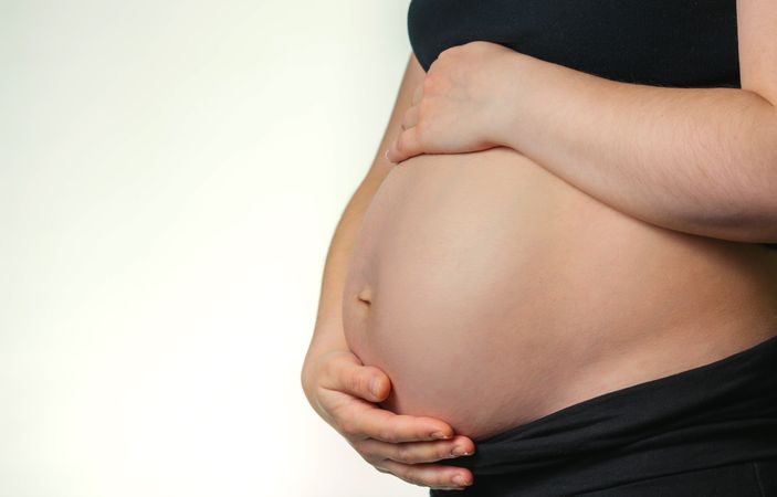Pregnant woman caressing her belly