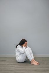 Woman covering her face with hands