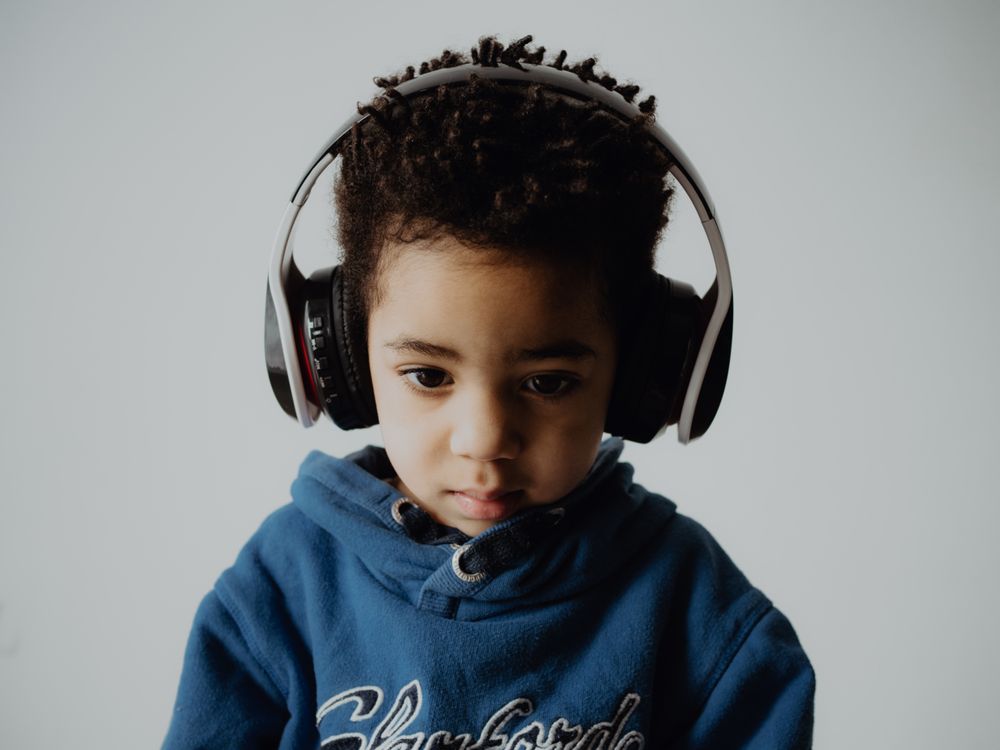 Black child listening to music