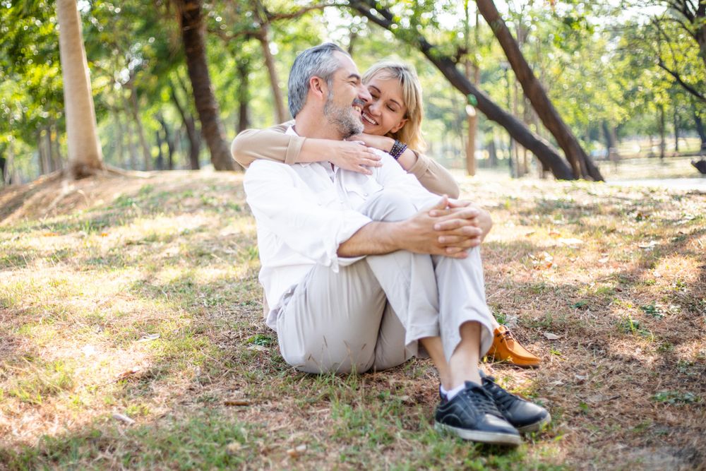 Woman holding her husband in the park
