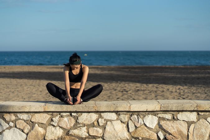 Woman stretching at seaside