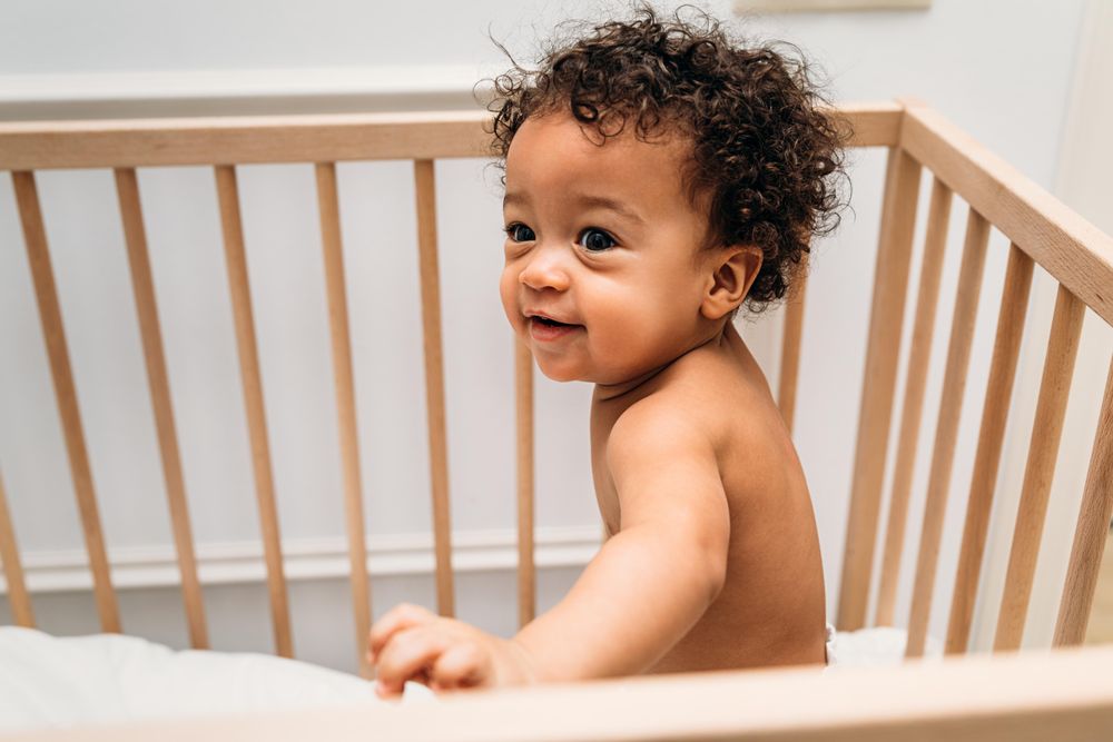 Cute baby boy in crib