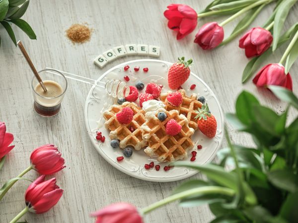 Waffles with berries near Gofres inscription