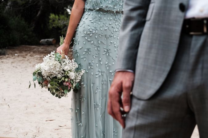 Happy married couple in wedding clothing at forest