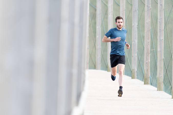 Sportsman jogging outdoors under cover