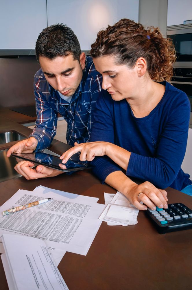 Couple discussing their monthly bills in kitchen