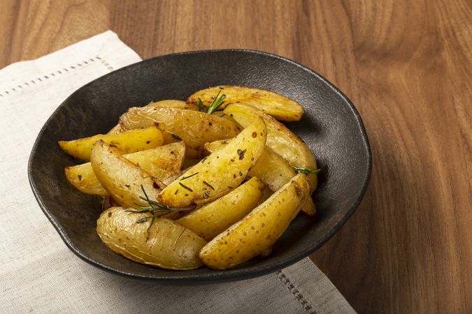 Roasted potatoes with rosemary on the plate.