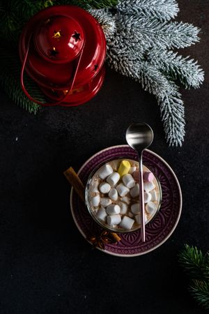 Top view of marshmallow hot chocolate on table with red lantern