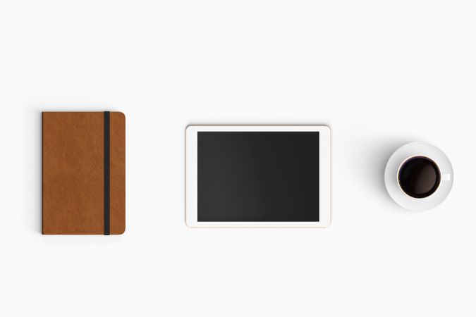 Modern workspace with coffee cup, smartphone, paper, notebook and tablet copy space