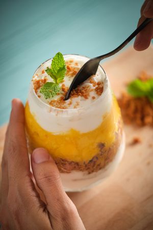 Woman with glass of sweet cheesecake