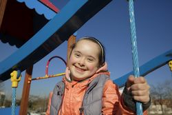Sweet happy little girl at the playground smiling and looking at camera