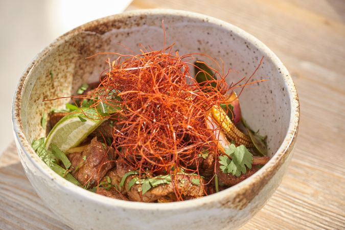 Bowl of chicken and lime with chili threads