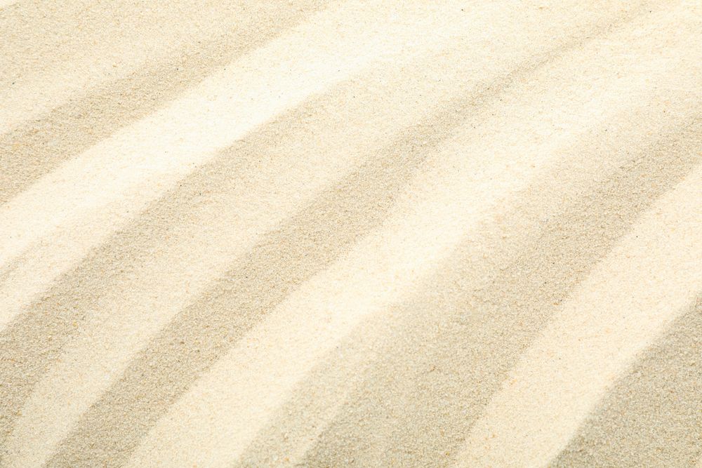 Clear sea sand as background, space for text and closeup. Summer vacation background