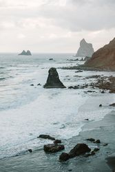 Lonely cliff in sea on cloudy day