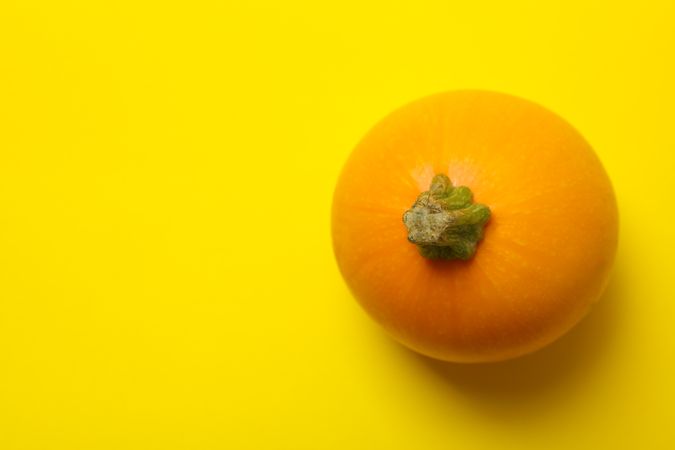 Round zucchini on yellow background, top view