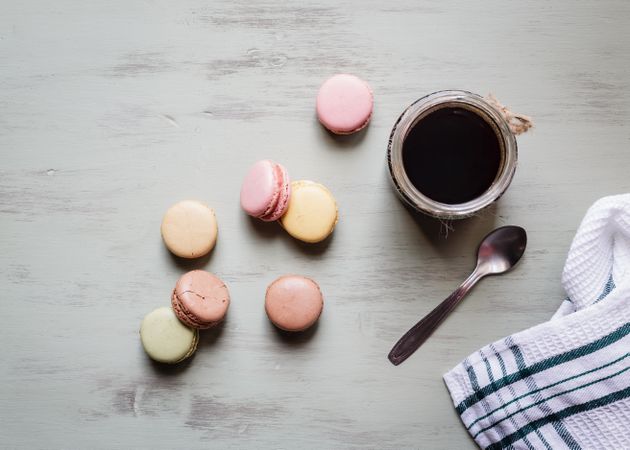 Spoon and napkin near coffee and macaroons