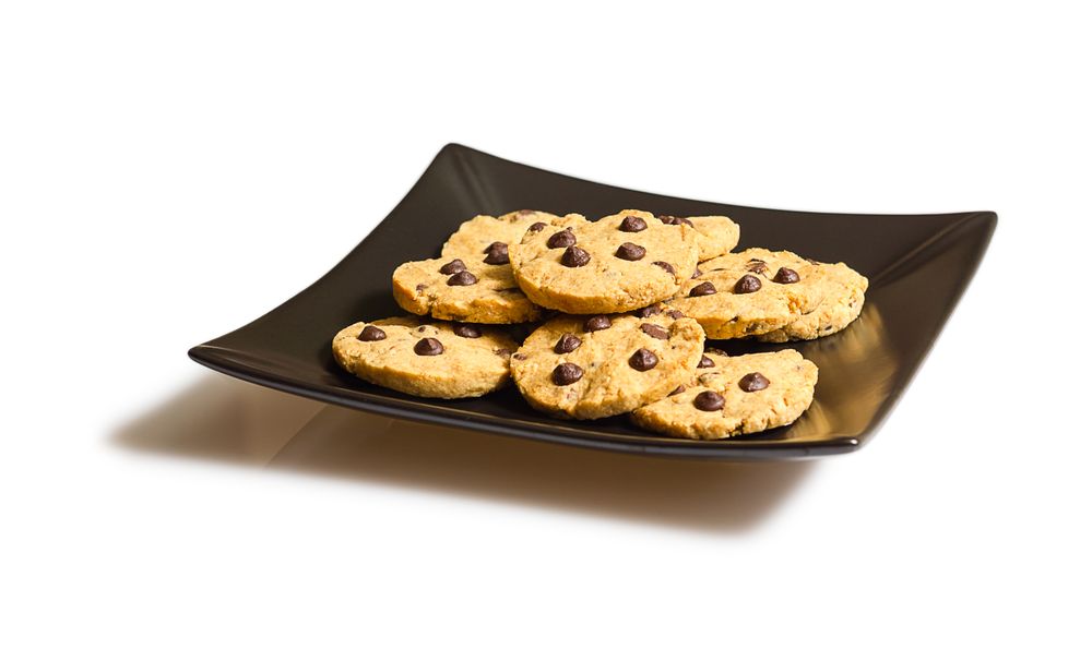 Chocolate chip cookies on a dark plate isolated on plain background