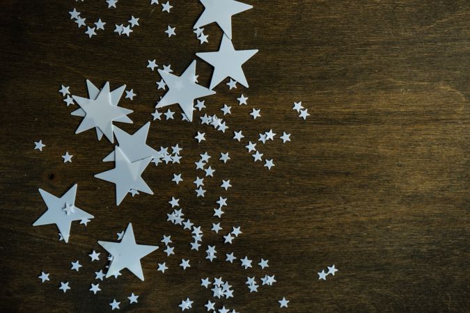 Star decorations scattered on wooden table with copy space