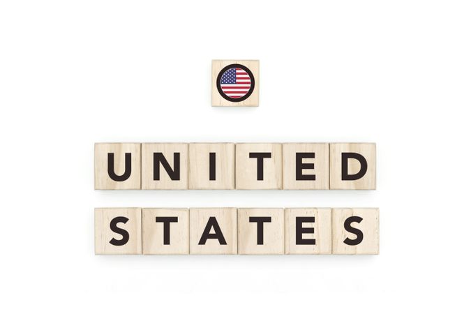 Wooden blocks bearing the name and flag of United States. American Culture, national identity, travel, and geography in a copy space design.