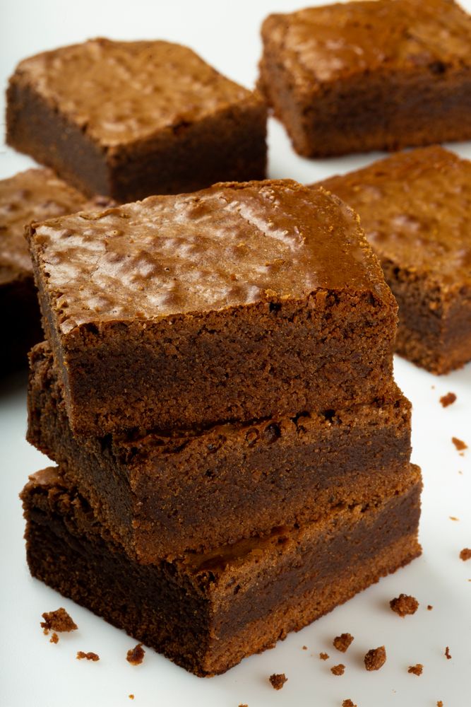 Pile of freshly made chocolate brownies, vertical