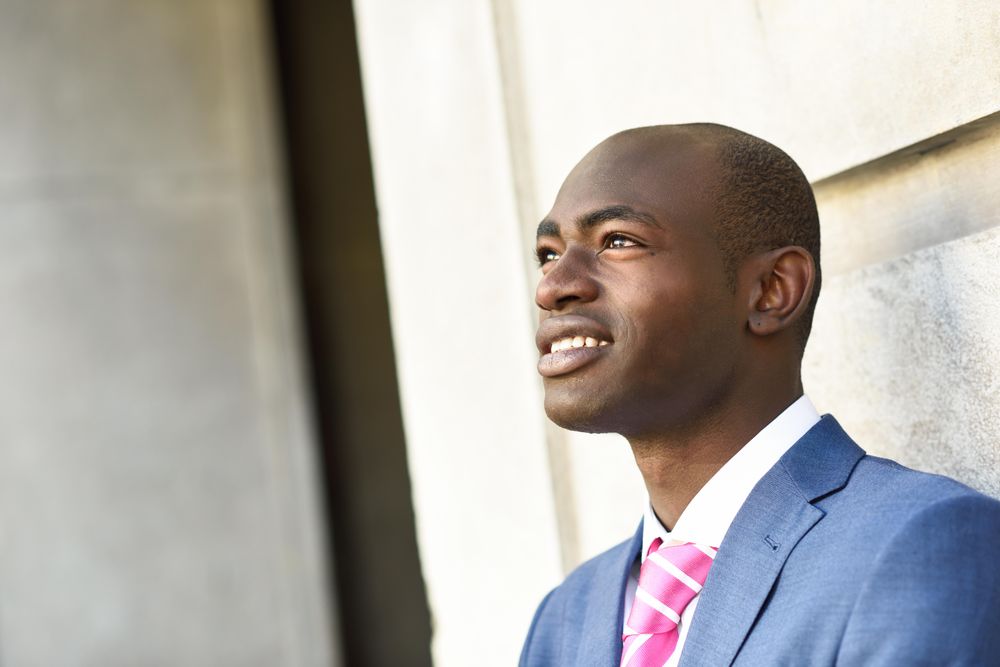 Confident male in business attire looking up with copy space