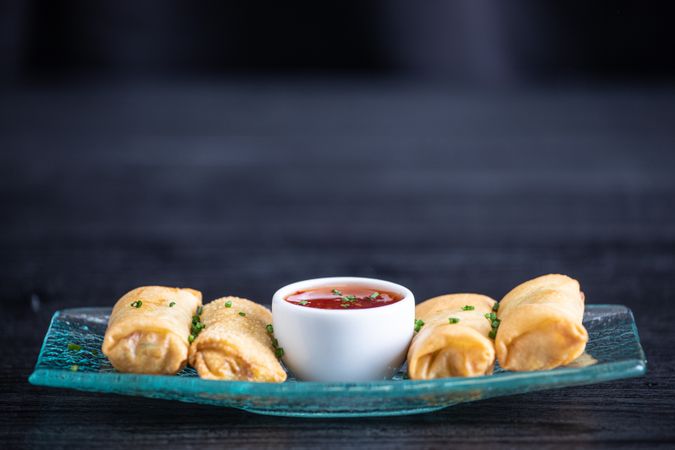 Vietnamese rolls with sweet chili on glass plate