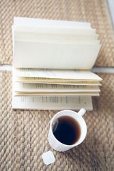 Hot tea near open book