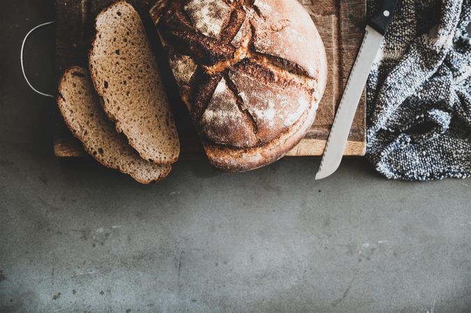 Freshly baked sourdough bread loaf, sliced, close up, copy space