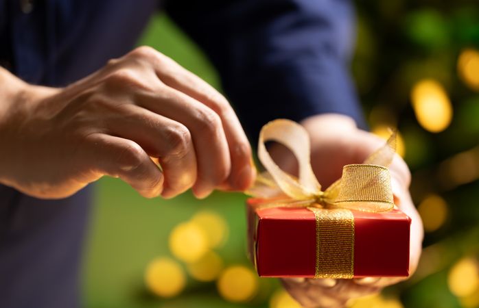 Male Hands Opening Holiday Present