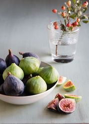 Plate of fresh ripe figs on kitchen table