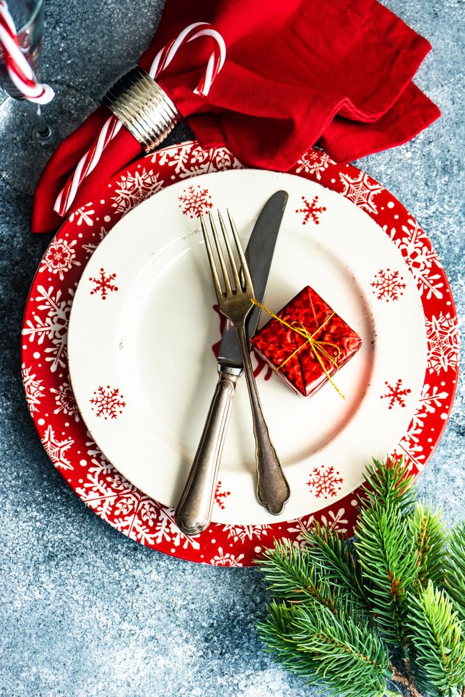 Christmas dinner concept with seasonal red plate and decorative plate