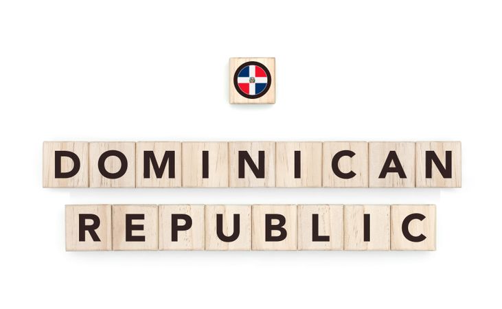 Wooden blocks bearing the name and flag of Dominican Republic. Dominican and Caribbean Culture, national identity, travel, and geography in a copy space design.