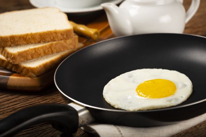 Breakfast with fried egg in the frying pan.