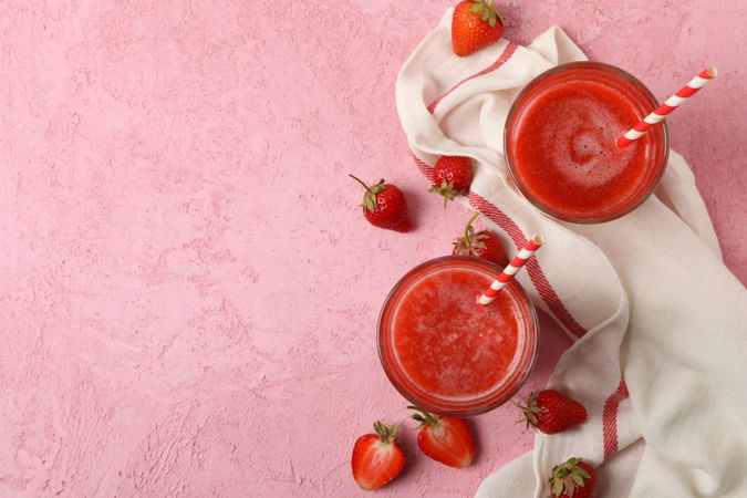 Composition with strawberry cocktails on pink table. Summer drink