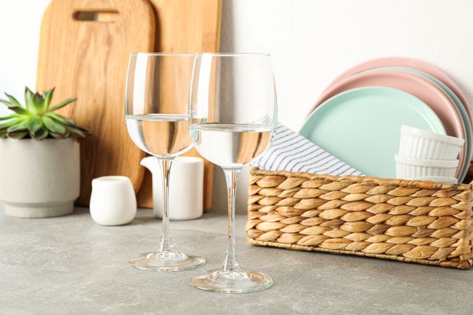 Set of dinnerware with succulent plant on grey table, space for text