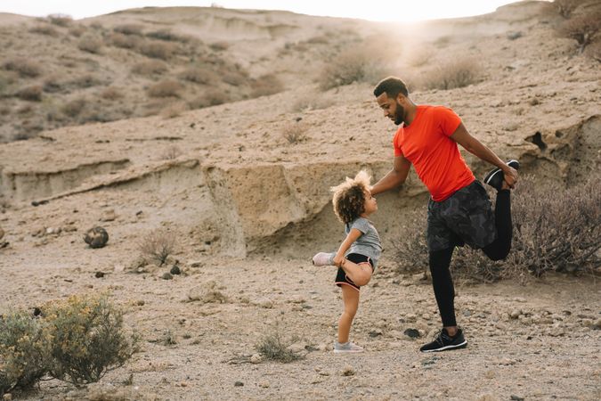Black father preparing for sport training with child
