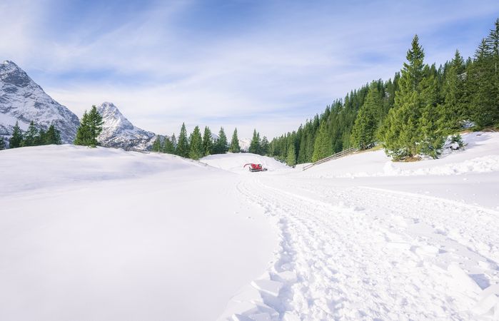 Fresh road through snow in mountains