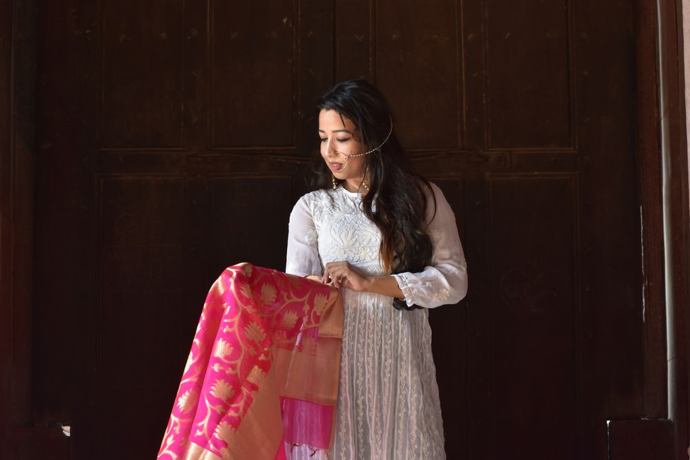 Woman in light dress looking at her sari