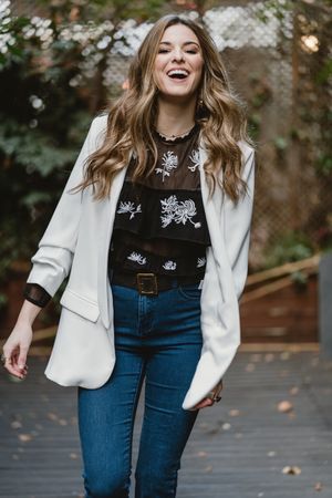 Woman standing on planter in garden