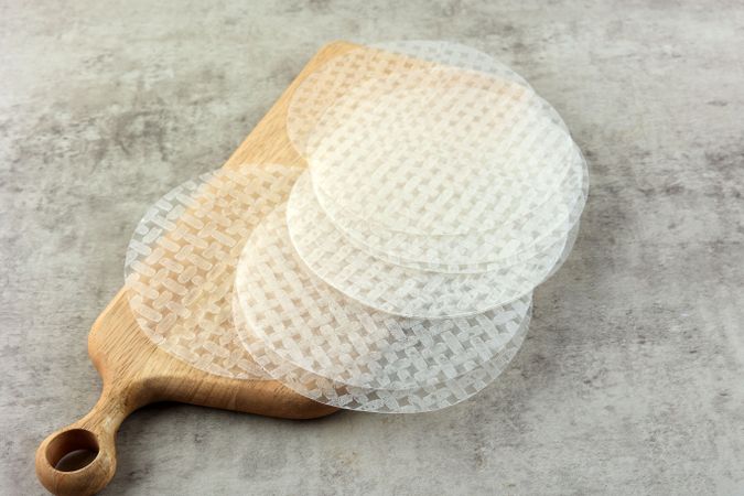Edible Rice Paper Sheets and Ingredients on Rustic Table